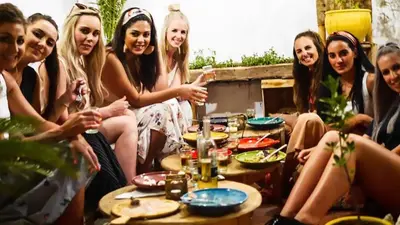 a group of women sitting around a table with drinks at Happy Marrakchy in Marrakech