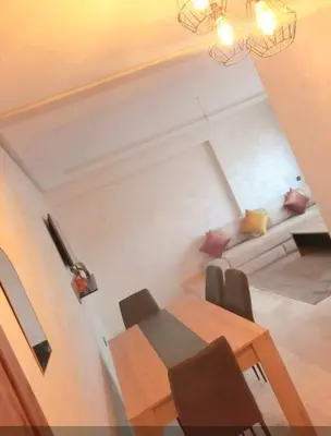 a living room with a table and a couch at Appartement tout neuf en plein centre de Marrakech in Marrakech