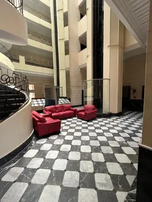 a lobby with red couches and a checkered floor at Marrakech M Avenue terrasse jardin in Marrakech