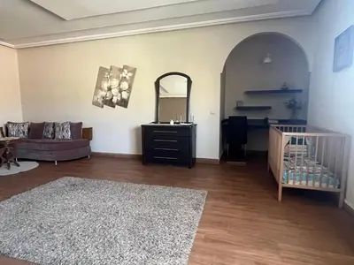 a living room with a couch and a crib at Marrakech le joyau villa piscine privée jardin in Marrakech