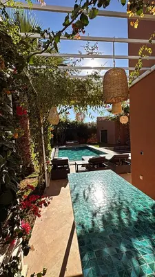 a swimming pool in a house with a patio at Villa M Piscine chauffée, Hammam sans vis à vis Marrakech in Marrakech