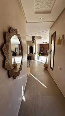 a room with a mirror on the wall and a hallway at Villa M Piscine chauffée, Hammam sans vis à vis Marrakech in Marrakech