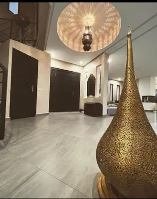 a room with a vase in the middle of a room at Villa M Piscine chauffée, Hammam sans vis à vis Marrakech in Marrakech