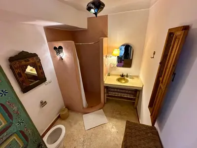 a small bathroom with a sink and a shower at Riad Dar Malwan Hotel and Massage in Marrakech