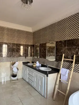 a bathroom with a sink and a counter at Maison Jannate Louise in Marrakech