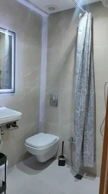 a bathroom with a toilet and a shower curtain at Duplex haut standing, 3 chambres ,Marrakech,gueliz in Marrakech