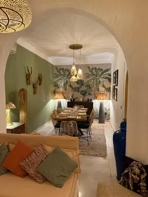 a living room with a couch and a table at Magnifique Riad Julilu Privatise au coeur de la Medina 11P in Marrakech