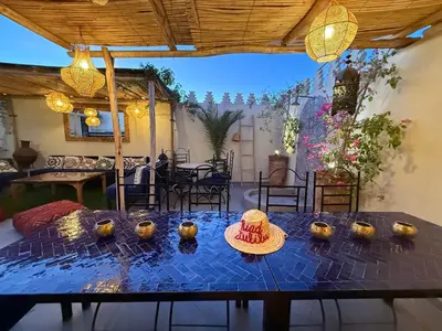 a dining room with a table with a hat on it at Magnifique Riad Julilu Privatise au coeur de la Medina 11P in Marrakech