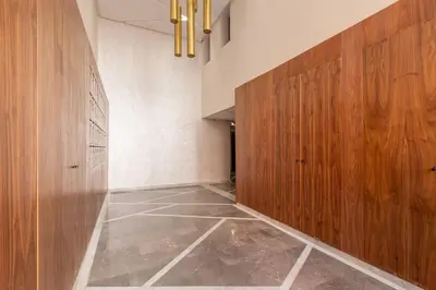 a hallway with wooden doors and a tiled floor at New! Marvellous'n modern flat in Marrakech