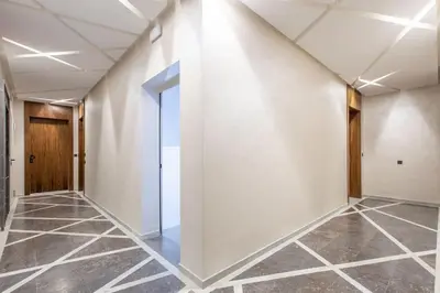an empty hallway with white walls and tile floors at New! Marvellous'n modern flat in Marrakech