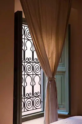 a window with a curtain in front of it at Exclusive and stylish 4-bedroom Riad with plunge pool in Marrakech