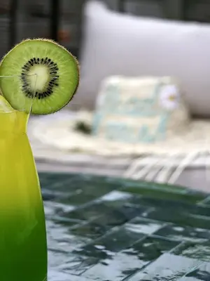 a kiwi fruit sitting on top of a green vase at Riad Almisk in Marrakech