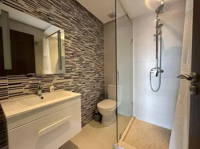 a bathroom with a sink and a toilet and a shower at Lovely family condo in residence Marrakech in Marrakech