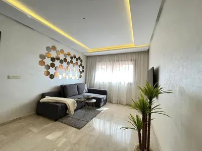 a living room with a couch and a table at Lovely family condo in residence Marrakech in Marrakech
