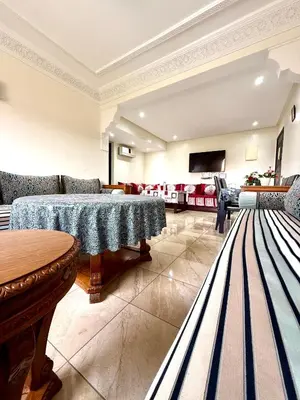 a living room with two tables and a couch at Appartement en résidence privée in Marrakech
