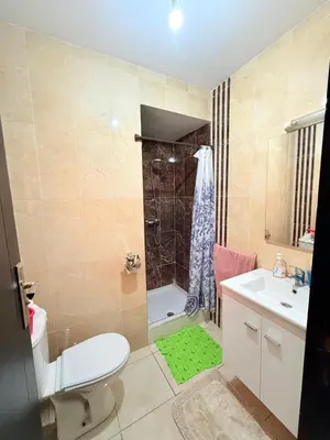a bathroom with a toilet and a sink and a shower at Appartement en résidence privée in Marrakech