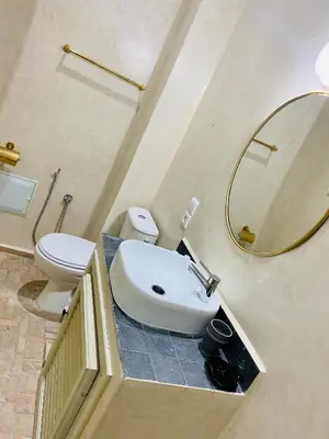 a bathroom with a sink and a toilet and a mirror at DAR Riad Jomana in Marrakech