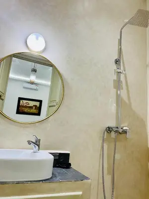 a bathroom with a sink and a mirror at DAR Riad Jomana in Marrakech