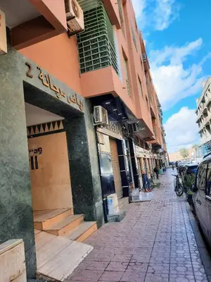 a city street with a building and a cobblestone sidewalk at Espace Harmony in Marrakech
