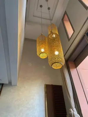 two chandeliers hanging from a ceiling in a room at Duplex Cosy dans résidence avec piscine in Marrakech