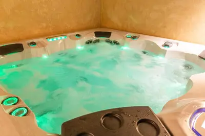 a bath tub filled with blue water in a bathroom at VILLA 103 - Luxury Getaway - Private Jacuzzi in Marrakech