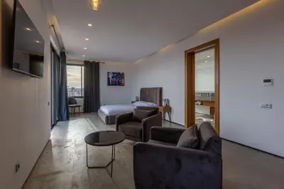 a living room with a couch and a bed at VILLA 103 - Luxury Getaway - Private Jacuzzi in Marrakech