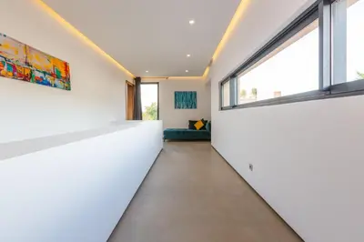 a hallway with white walls and large windows at VILLA 103 - Luxury Getaway - Private Jacuzzi in Marrakech