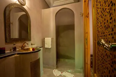 a bathroom with a sink and a mirror at Riad Petite Rose in Marrakech