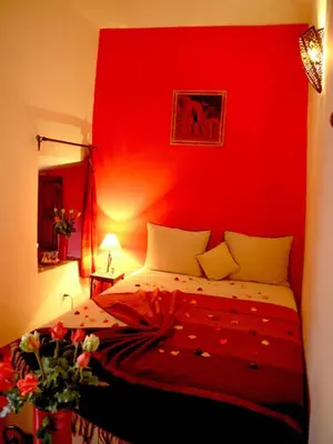 a red bedroom with a bed with a red wall at riad dar saba shika in Marrakech