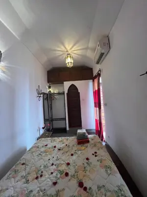 a bedroom with a large bed in a room at riad dar saba shika in Marrakech