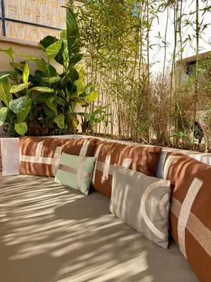 a row of pillows sitting on a patio at Riad Doum Collection 1 in Marrakech
