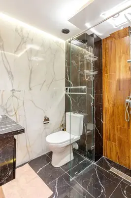a bathroom with a toilet and a glass shower at Appartement résidence Marrakech haut standing piscine in Marrakech