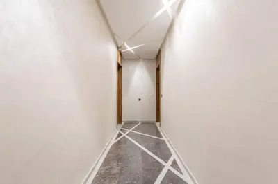 an empty hallway with white walls and concrete floors at New ! Splendid and cosy apartment in Marrakech