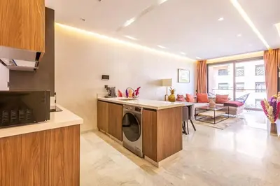 a kitchen and living room with a washer and dryer at New ! Splendid and cosy apartment in Marrakech