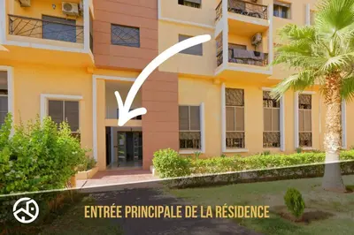 a building with a sign in front of it at Residence DES LILAS DAR SALAM chez Madame ASSYL residence avec 3 piscines in Marrakech