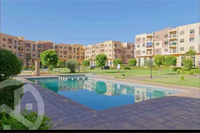 a swimming pool in front of a apartment complex at Residence DES LILAS DAR SALAM chez Madame ASSYL residence avec 3 piscines in Marrakech