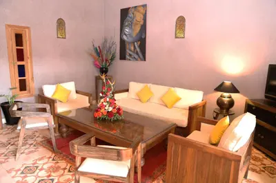 a living room with a couch and a table at Riad Ben in Marrakech