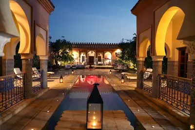 a courtyard with a pool in a building at Riad Ben in Marrakech