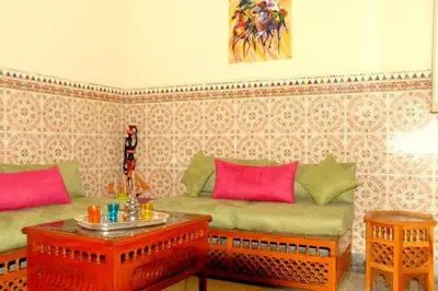 a living room with two couches and a table at Dar Khadija Familly in Marrakech