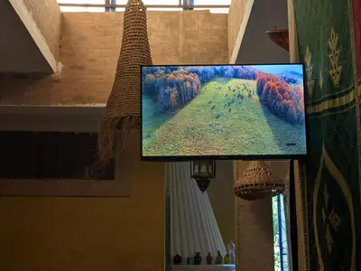 a flat screen tv hanging from a ceiling at Dar saafia in Marrakech