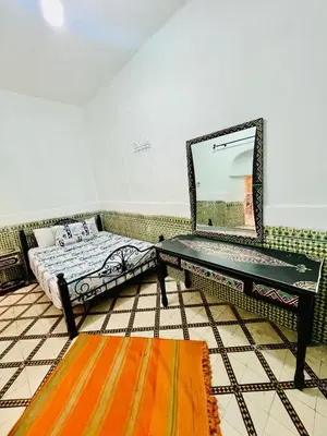 a room with a table with a mirror on it at Dar jamaa lfna in Marrakech