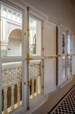 a room with three windows and a balcony at Riad Glatt K in Marrakech