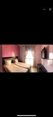 a hotel room with two beds and a lamp at appaartement M23 premium village in Marrakech
