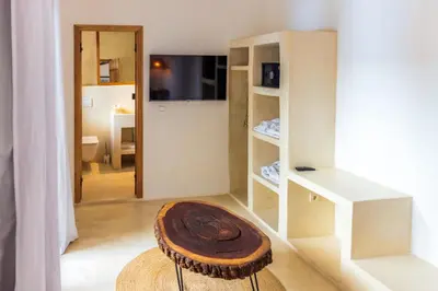 a room with a table and a stool in a room at Pure House Marrakech in Marrakech