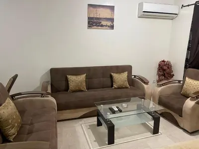 a living room with two couches and a coffee table at Appartement 17 3ème étage avec balcon POUR FAMILLE in Marrakech