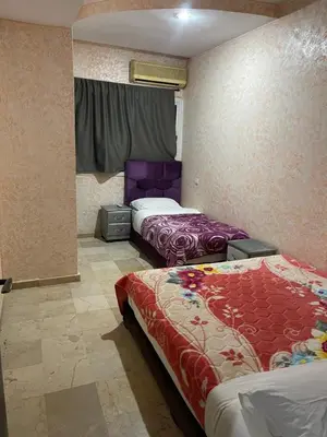 a room with two beds in a room at Appartement 1er étage numéro 7 POUR FAMILLE in Marrakech