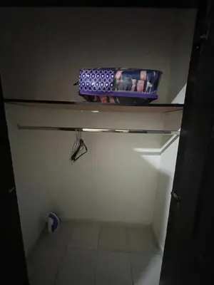 a shelf in a bathroom with a bottle on it at Appartement 1er étage numéro 7 POUR FAMILLE in Marrakech