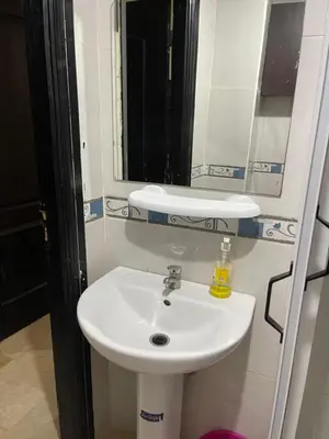 a bathroom with a white sink and a mirror at Appartement 1er étage numéro 7 POUR FAMILLE in Marrakech