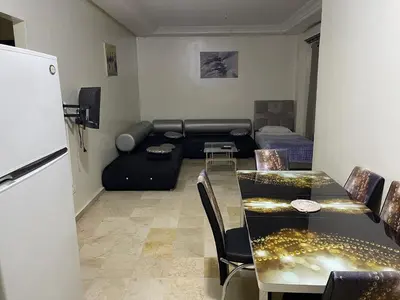 a living room with a couch and a table at Appartement 10 1èr étage. POUR FAMILLE in Marrakech