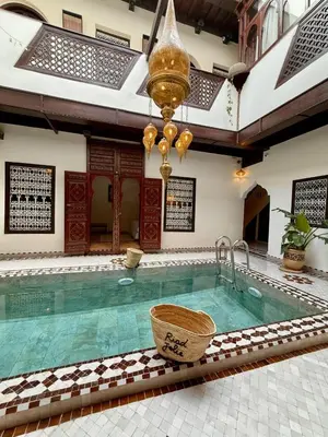 a large swimming pool with a basket in a building at Riad Jolie in Marrakech